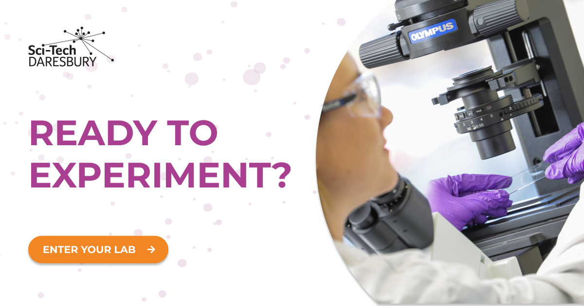 Purple call to action image with Sci-Tech Daresbury logo in the top left, with text overlay 'Ready to experiment?' Orange button underneath that says 'Enter your lab' with an arrow pointing right. Picture on the right of someone looking at a microbial slide under a telescope.